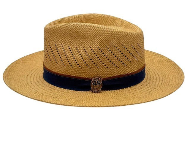 Fly Brims natural straw fedora with a structured crown, wide brim, and navy blue band featuring a metallic logo pin.